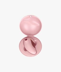 Rose gold wellness massager displayed inside its round protective case.
